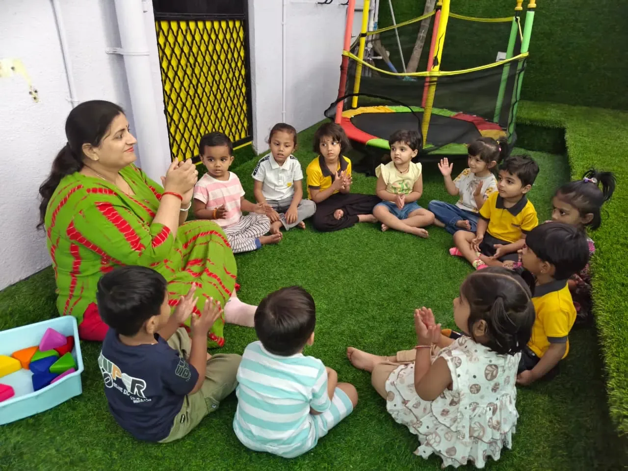 Teacher leading a group learning activity with children at Kidzee Mohan Nagar Baner